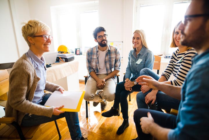 Training image - group of smiling people in a training session